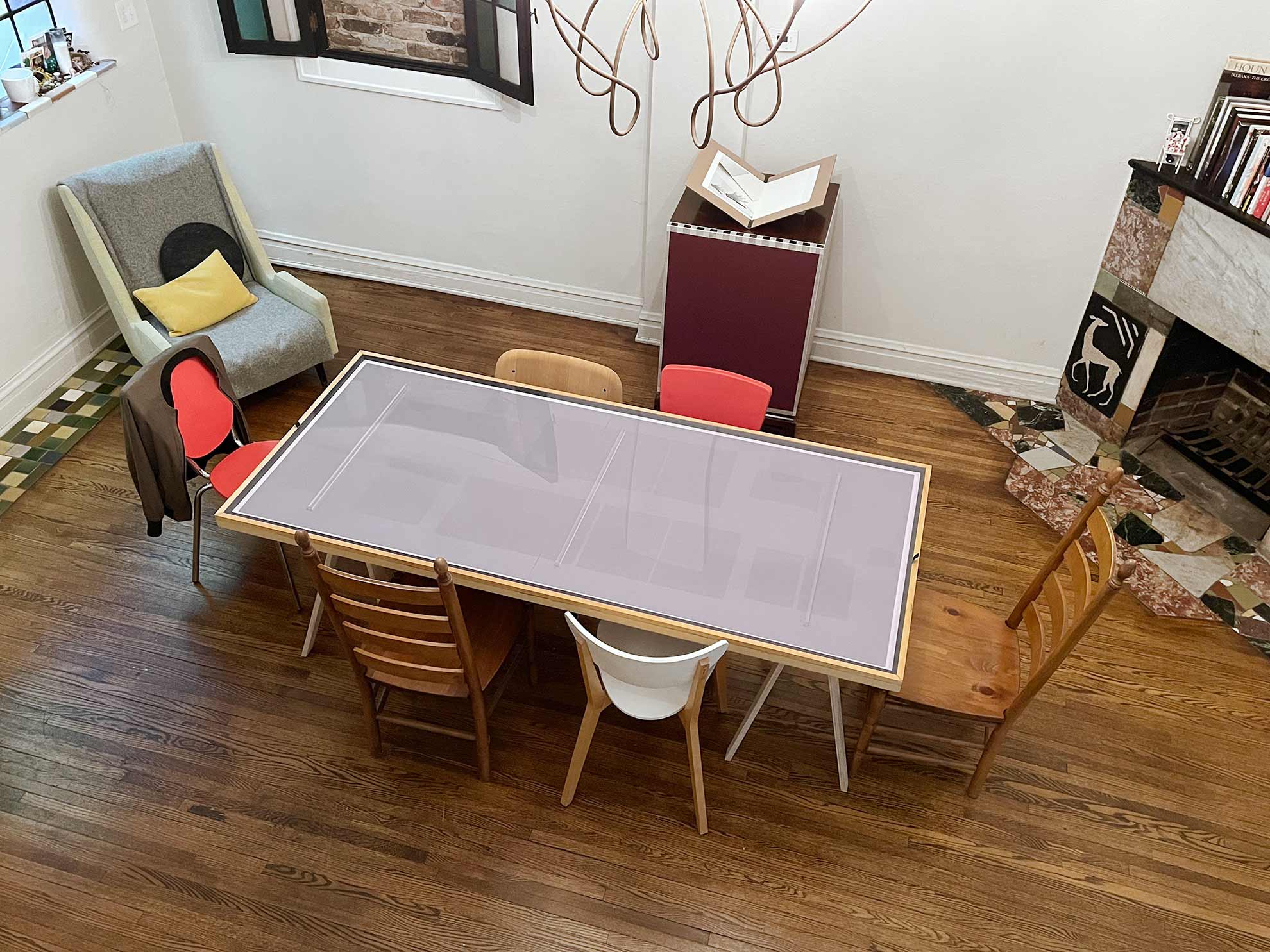 a convertible table surrounded by a mix of chairs